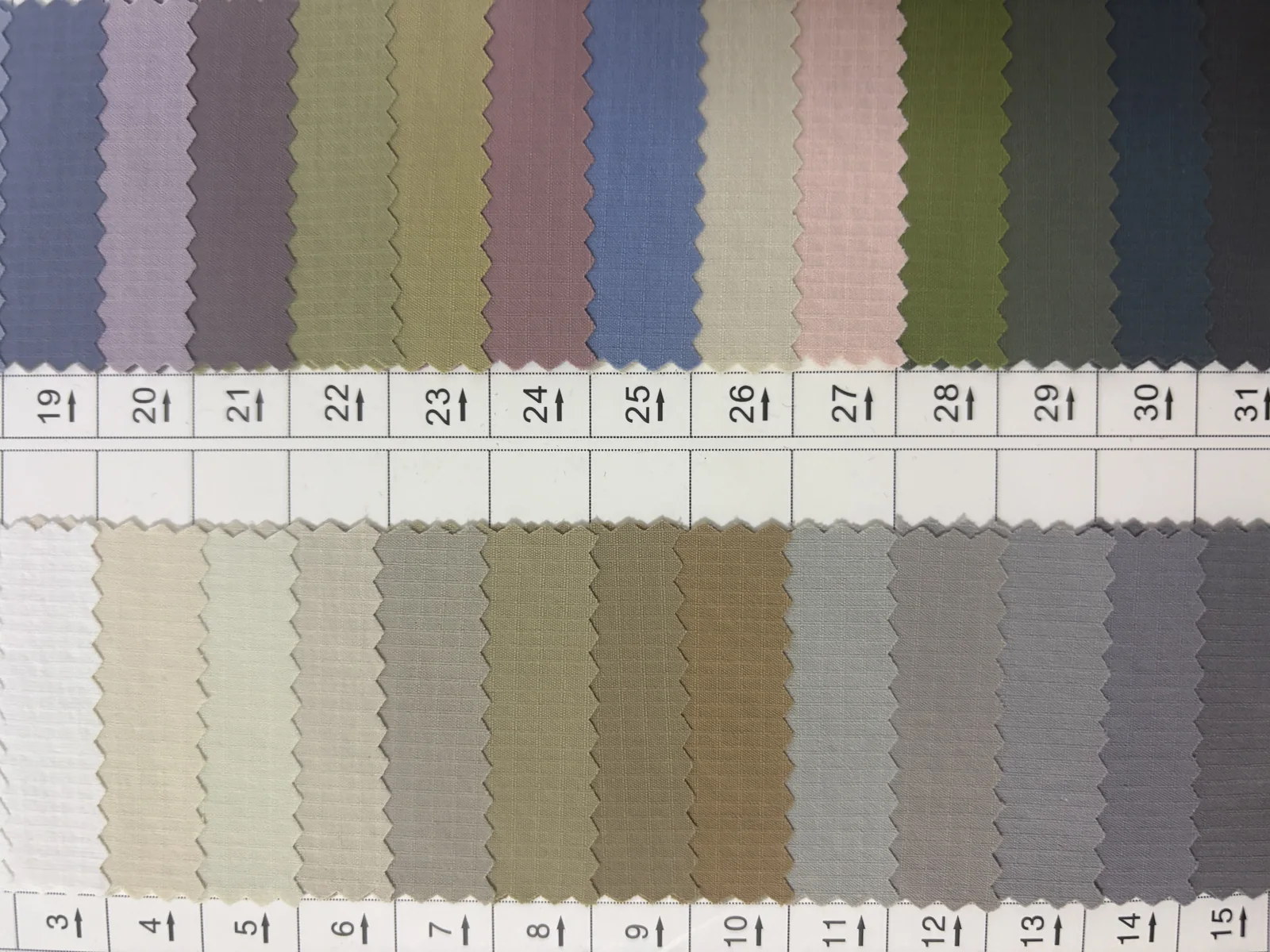 Woven performance fabric swatches in neutral, blue, green and muted outdoor colors