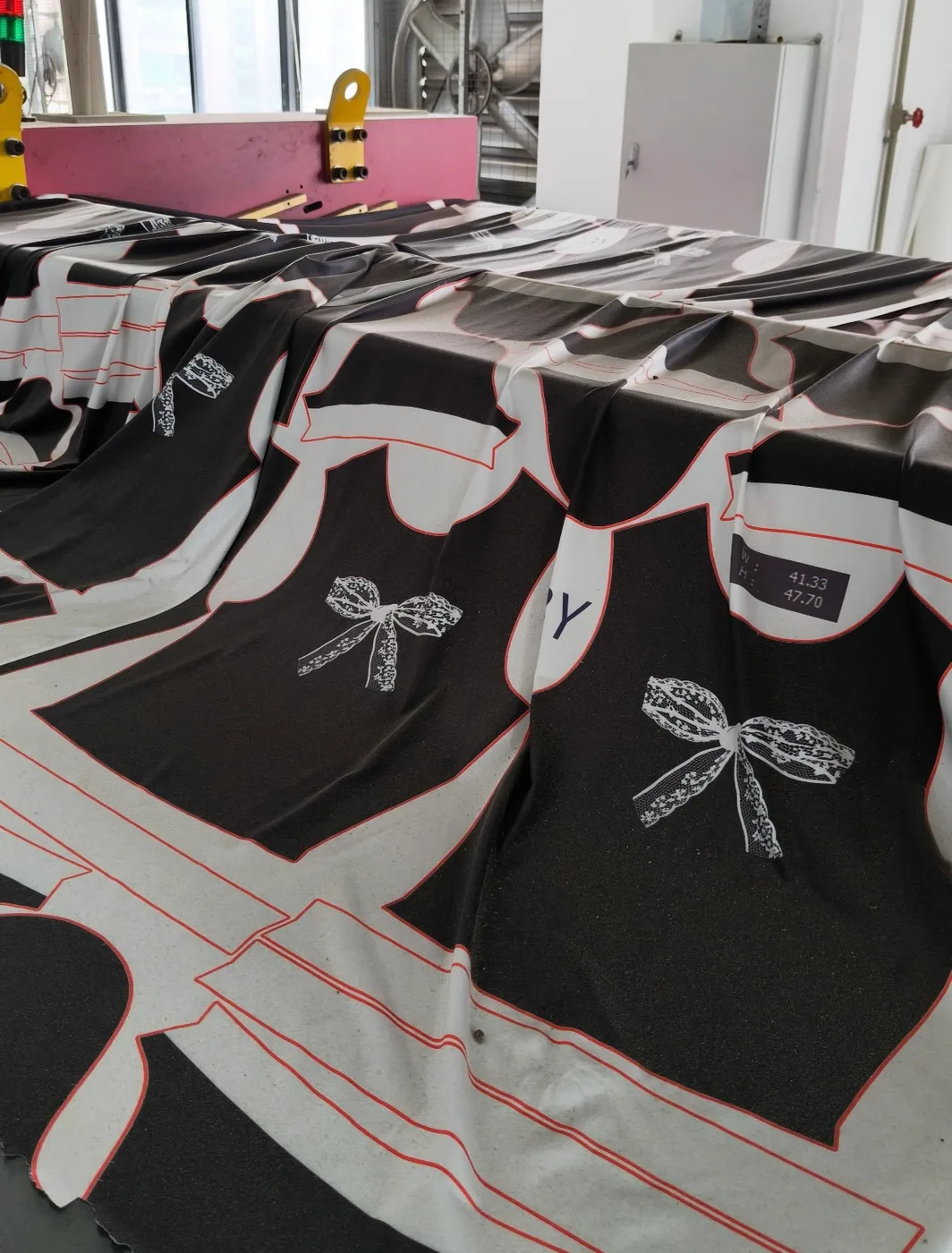 Factory table holding printed sublimation fishing polo panels before garment assembly
