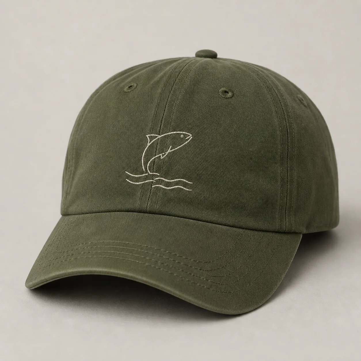 Fishing cap with low-profile flat embroidered fish and wave logo