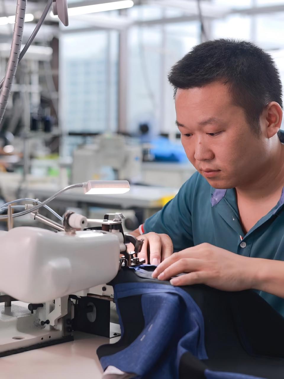Sewing custom fishing shirts in workshop